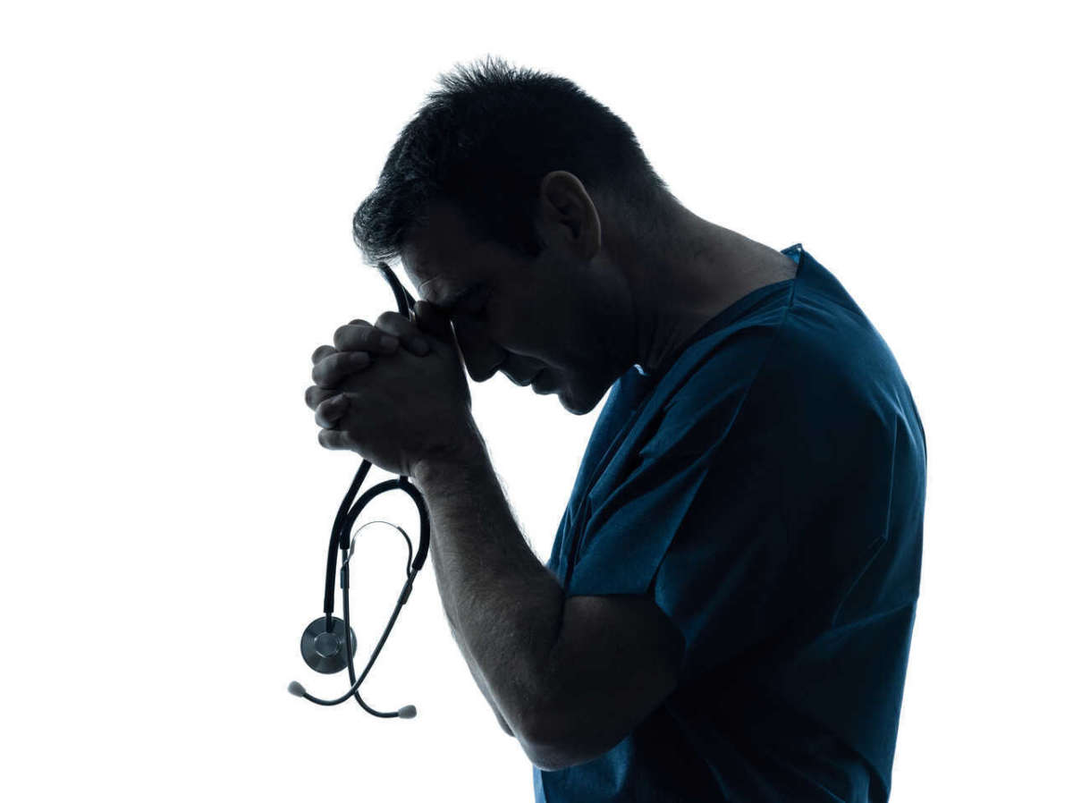 One,caucasian,man,doctor,surgeon,medical,worker,praying,silhouette,isolated